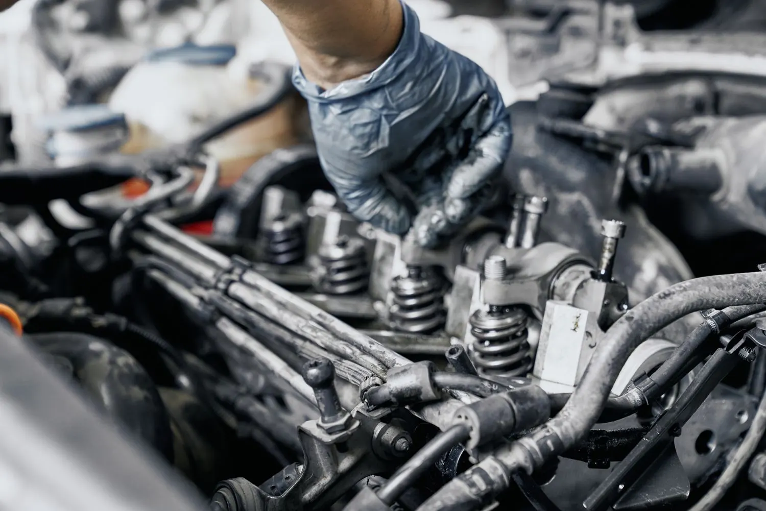 Close-up of diesel injector nozzles under an open bonnet